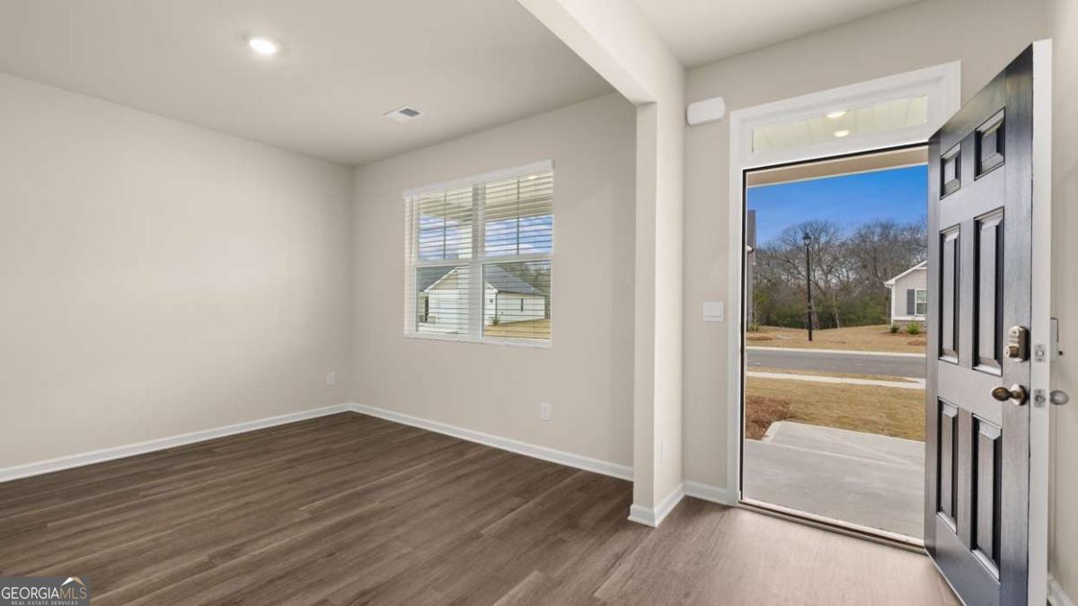 208 Cattle Drive Perry, GA 31069 - Photo 22 of 37 a view of a hallway with wooden floor and cabinet