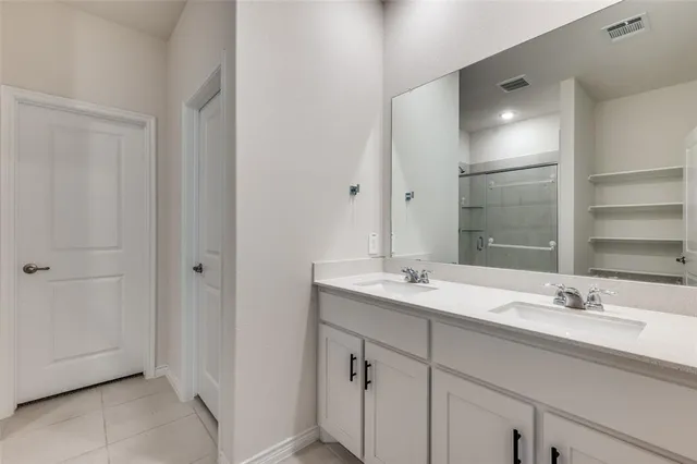 a bathroom with a sink double vanity and a mirror