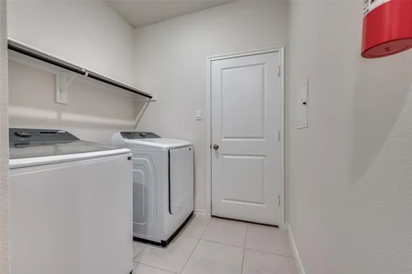 a view of a storage and utility room with washer and dryer