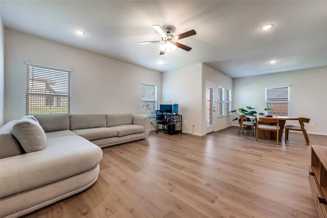 a living room with furniture and wooden floor