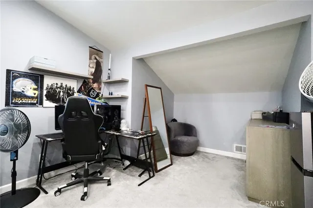 a view of a workspace with furniture and a window