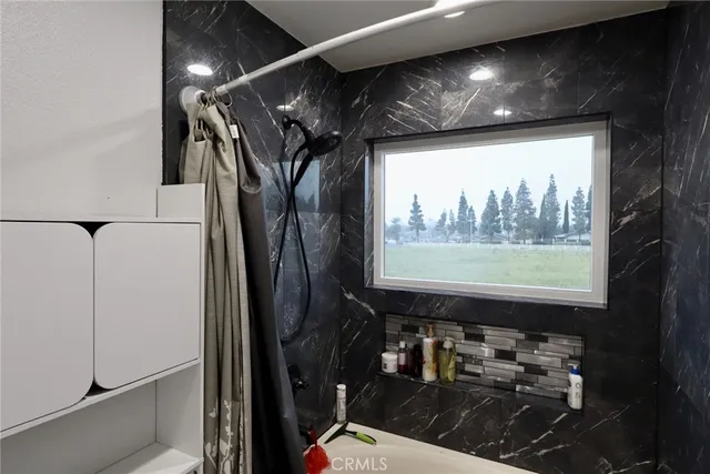 a room with water heater and a wooden floor