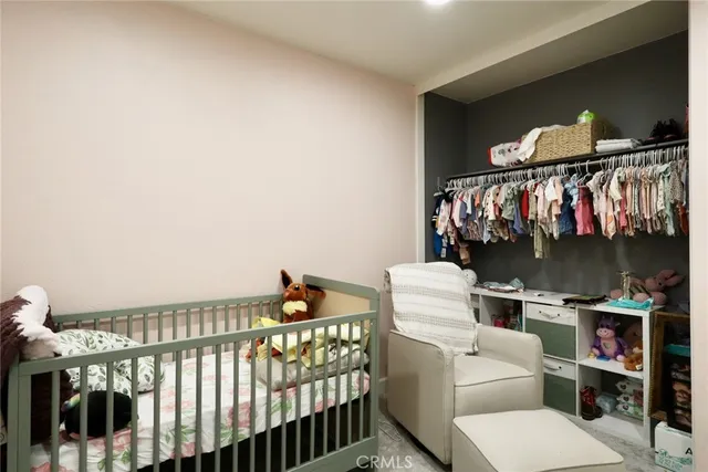 a bedroom with furniture and a baby bed