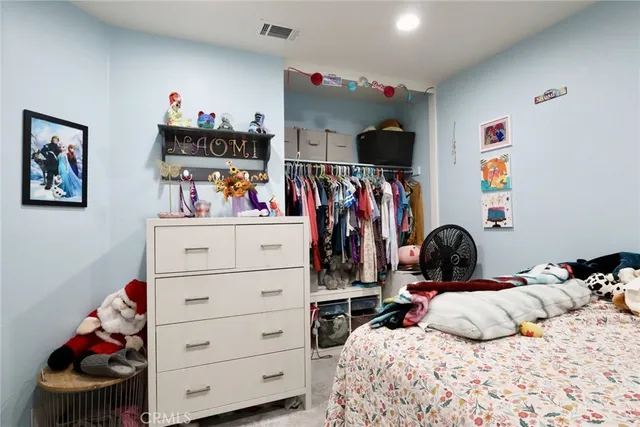 a bedroom with a bed and cabinets