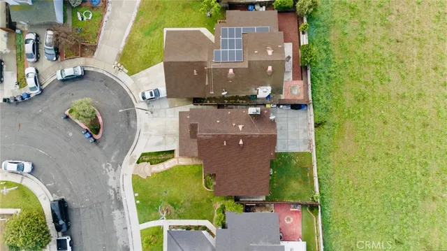 an aerial view of a house with outdoor space pool seating area and yard