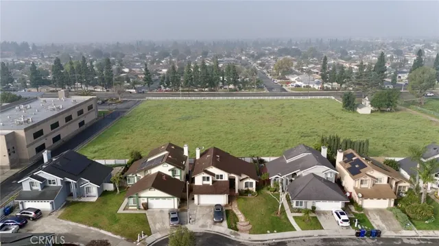 an aerial view of residential houses with outdoor space and river