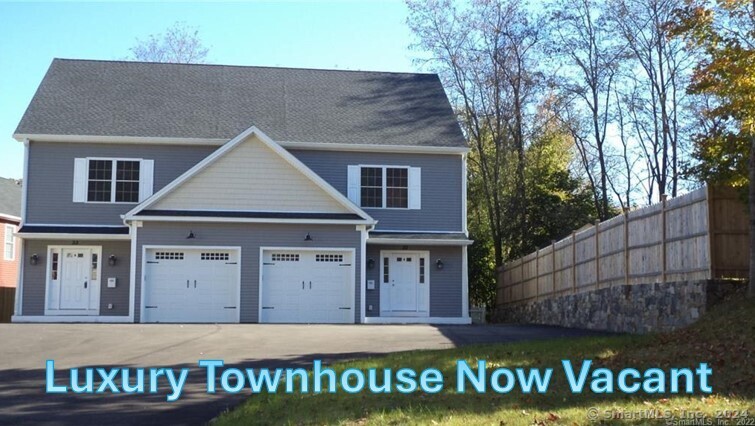 33 Maple Avenue, Unit A Bethel, CT 06801 - Photo 1 of 1 a front view of a house with a tree