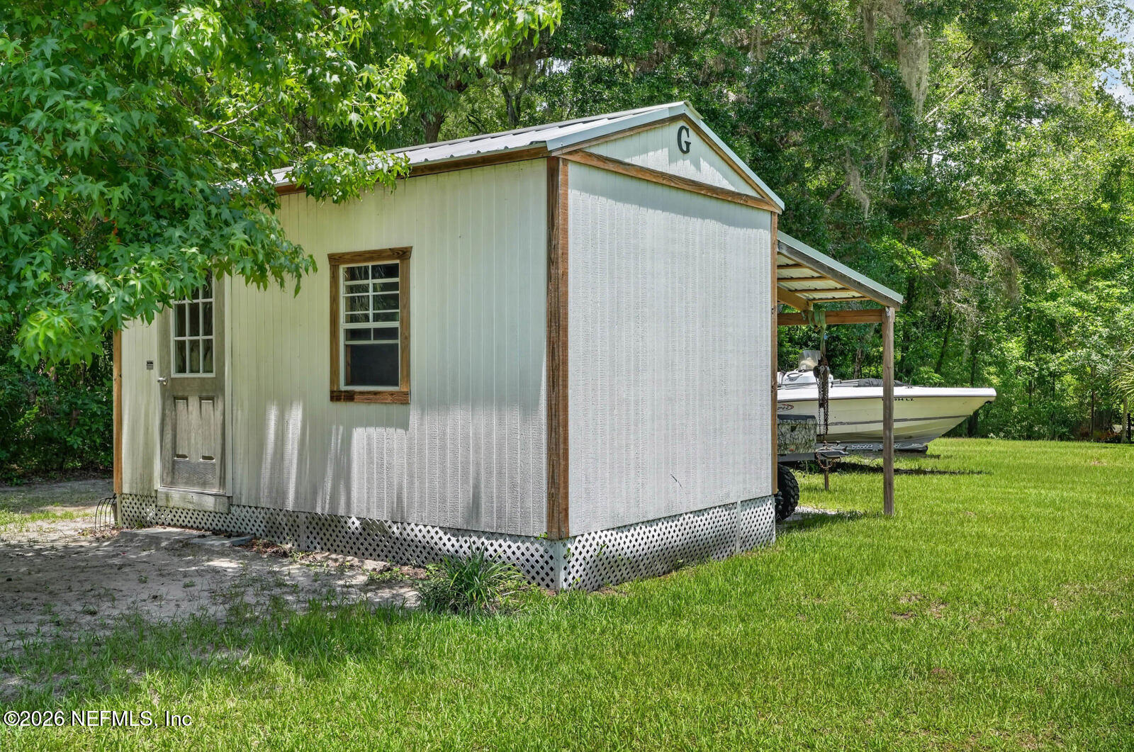 264 Peniel Church Road Palatka, FL 32177 - Photo 36 of 48 a backyard of a house with table and chairs