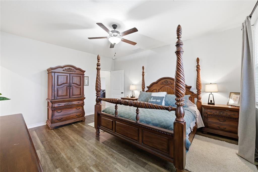 1292 Whiskey Hollow Road West, TX 76691 - Photo 16 of 34 Bedroom with ceiling fan and wood finished floors