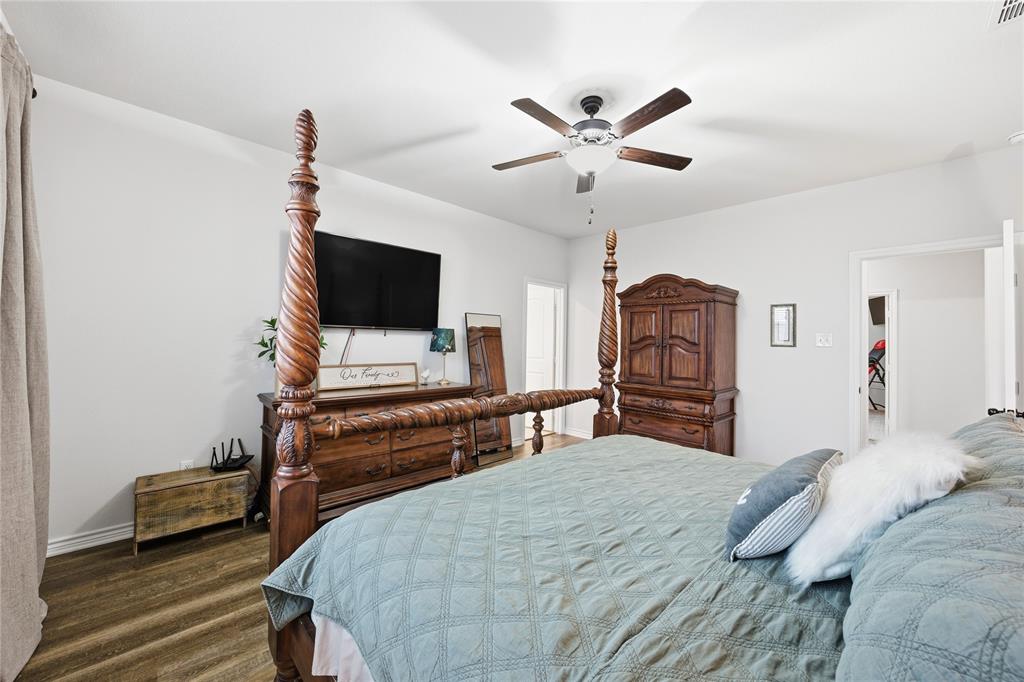 1292 Whiskey Hollow Road West, TX 76691 - Photo 17 of 34 Bedroom with dark wood finished floors and a ceiling fan