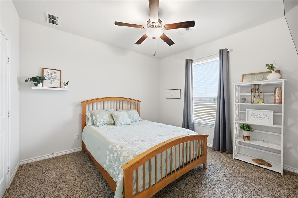 1292 Whiskey Hollow Road West, TX 76691 - Photo 22 of 34 Bedroom featuring a ceiling fan and carpet flooring
