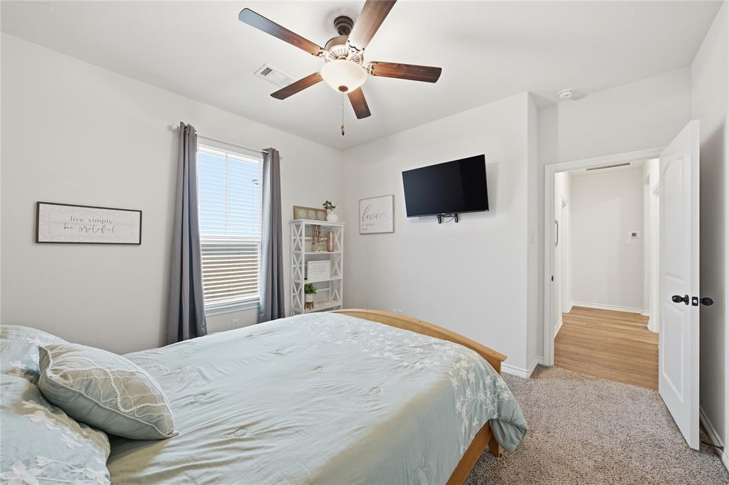 1292 Whiskey Hollow Road West, TX 76691 - Photo 23 of 34 Bedroom featuring light carpet and ceiling fan