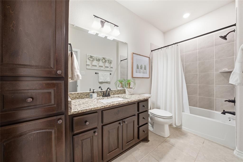 1292 Whiskey Hollow Road West, TX 76691 - Photo 24 of 34 Bathroom featuring vanity, shower / tub combo, light tile patterned flooring, and recessed lighting