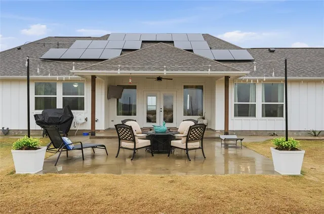 a swimming pool with outdoor seating and patio