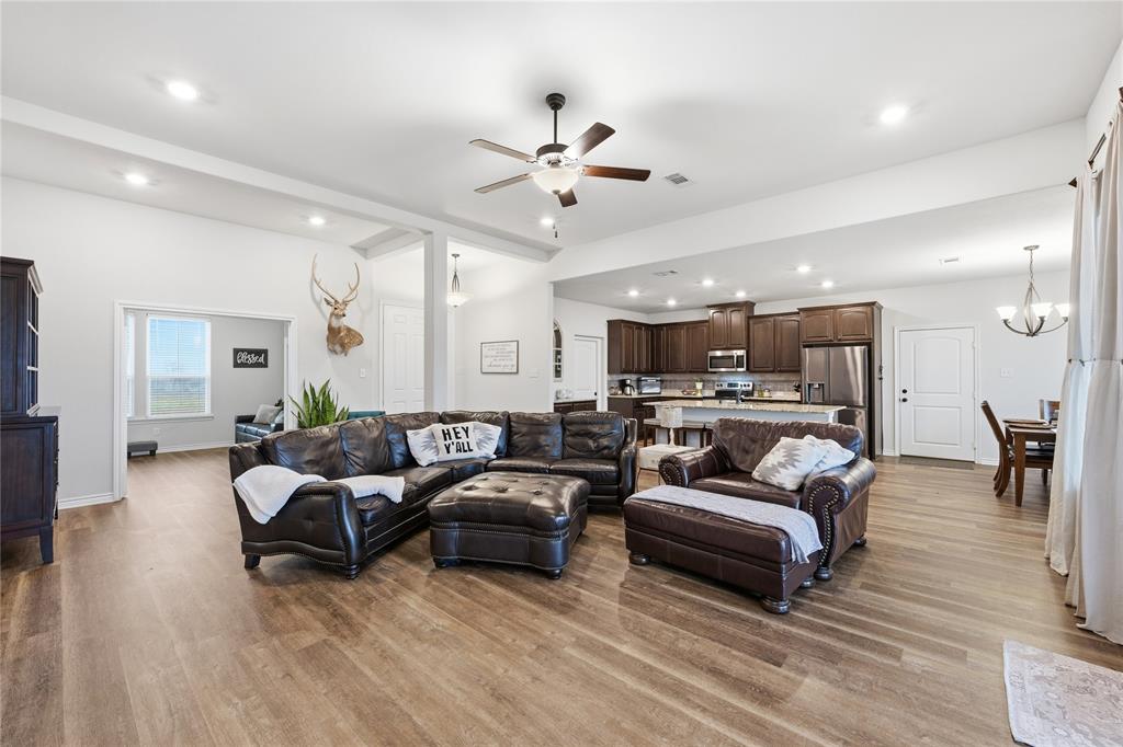 1292 Whiskey Hollow Road West, TX 76691 - Photo 7 of 34 Living area featuring a chandelier, ceiling fan, dark wood-type flooring, and recessed lighting