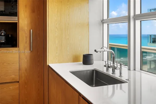 a bathroom with a granite countertop sink a mirror and shower