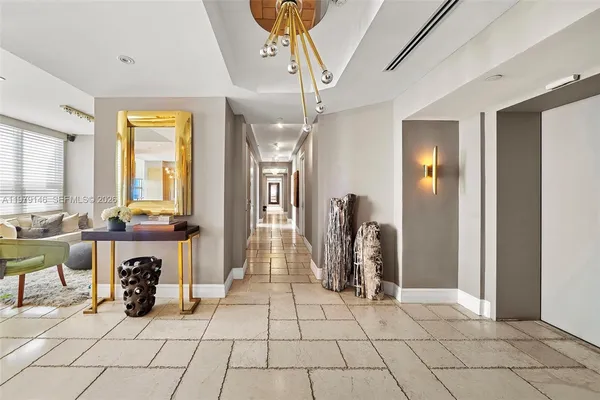 a bed room with a bed mirror and a chandelier