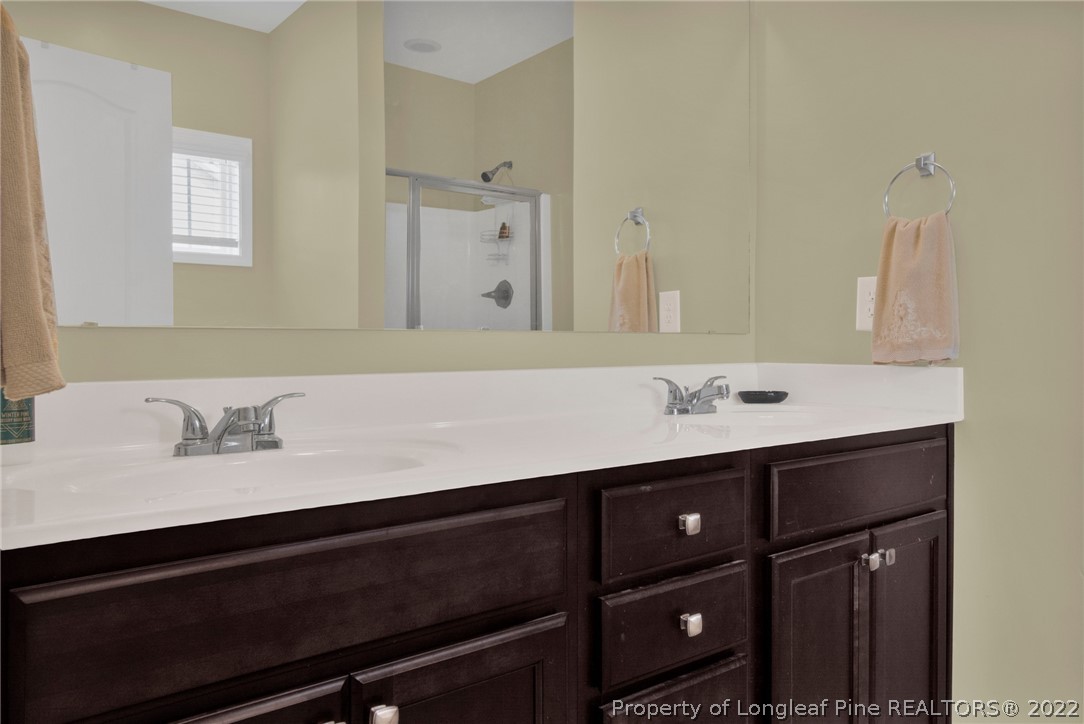 809 Montrose Road Raeford, NC 28376 - Photo 15 of 33 a bathroom with a sink vanity and a mirror