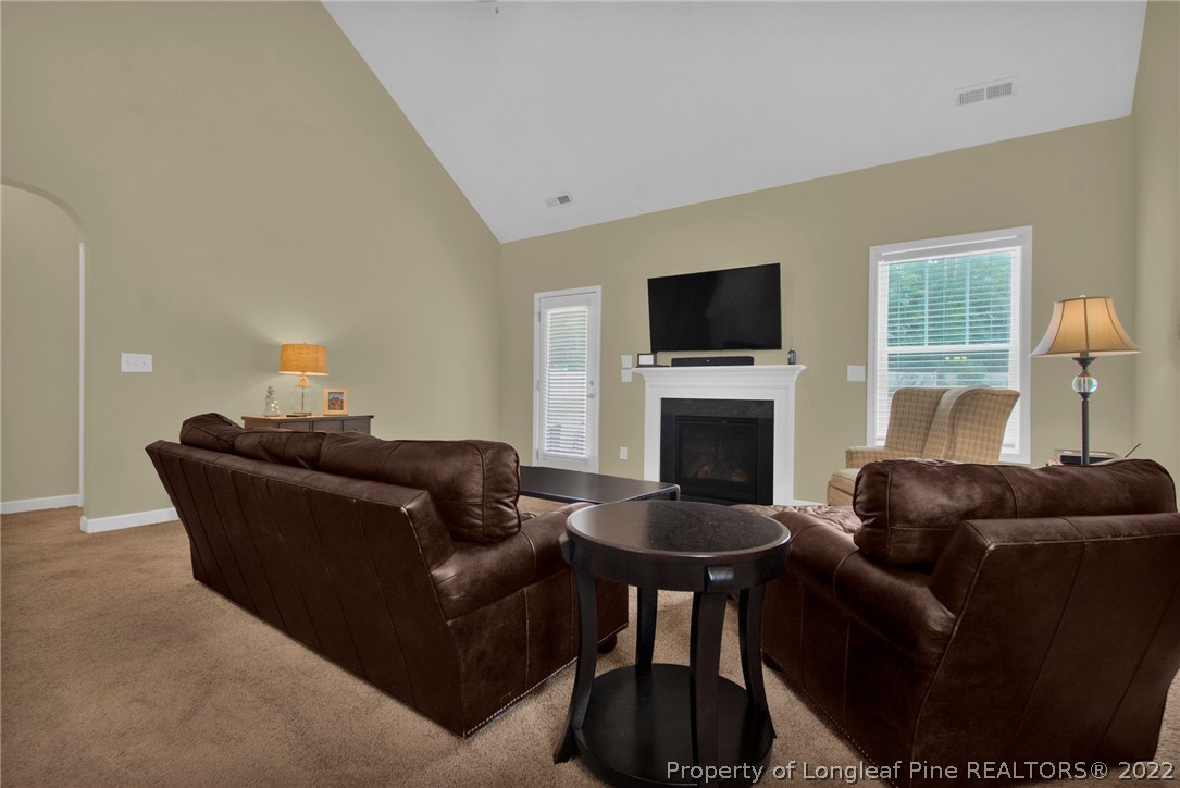 809 Montrose Road Raeford, NC 28376 - Photo 31 of 33 a living room with furniture a fireplace and a flat screen tv