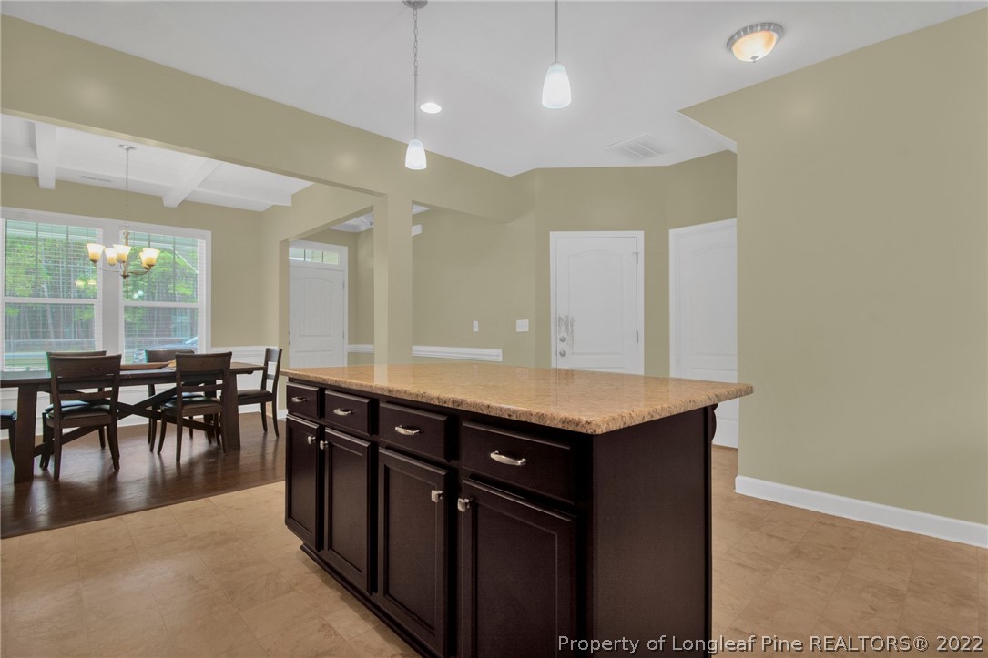 809 Montrose Road Raeford, NC 28376 - Photo 6 of 33 an open kitchen with a table and chairs
