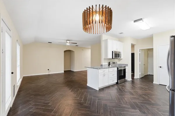 a view of a kitchen with a sink and a refrigerator