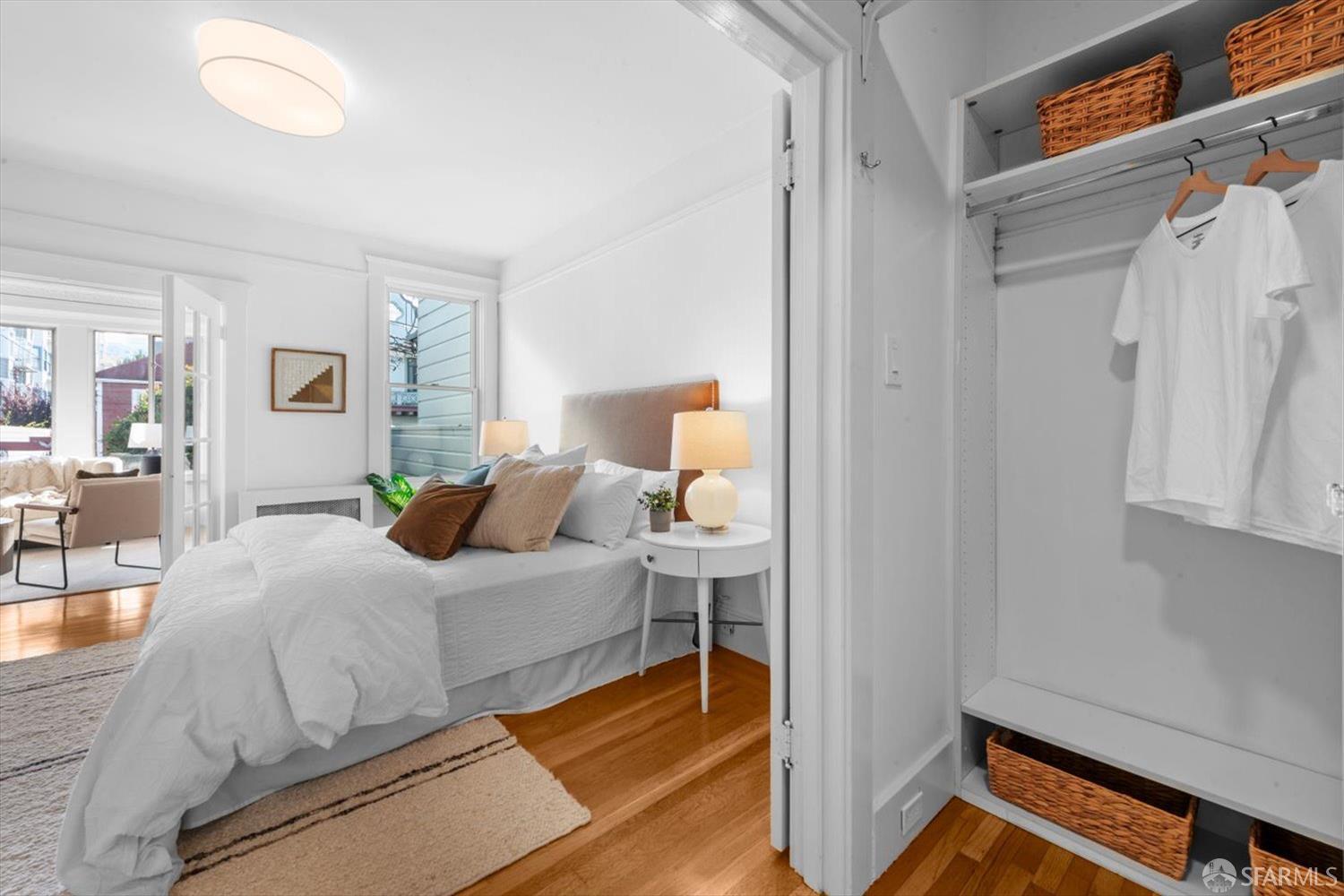 1624 Filbert Street, Unit 1 San Francisco, CA 94123 - Photo 31 of 47 a bedroom with a bed and a chandelier