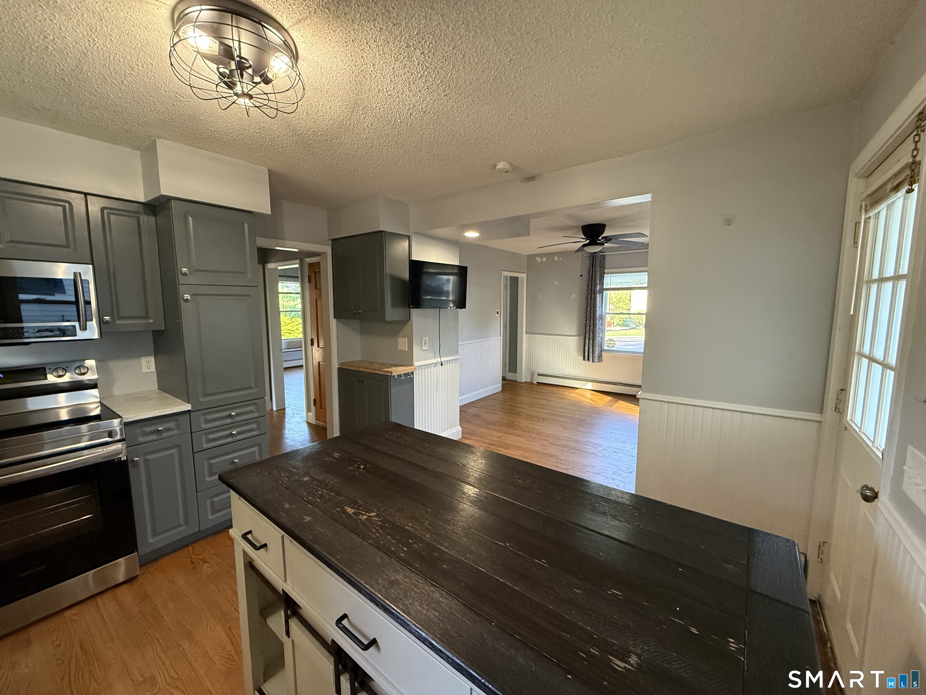 808 East Main Street Torrington, CT 06790 - Photo 14 of 40 a kitchen with kitchen island a counter space a sink appliances and cabinets