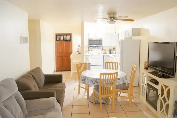 a living room with furniture a flat screen tv and a table