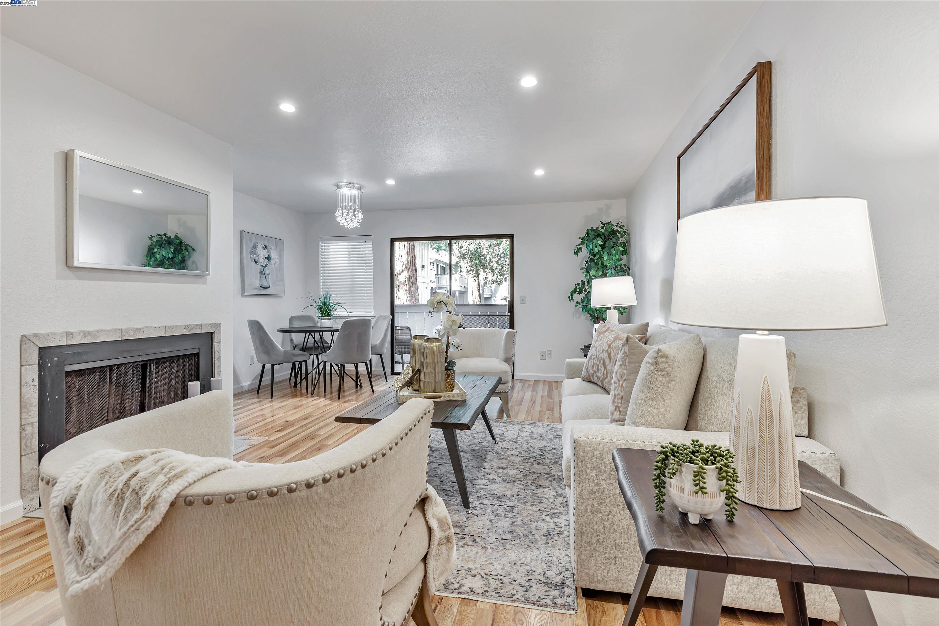 a living room with furniture a fireplace and a table