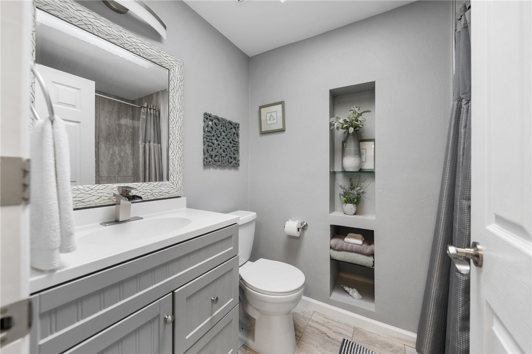 35825 Meadow Ridge Road Temecula, CA 92592 - Photo 49 of 75 a bathroom with a sink a toilet and mirror