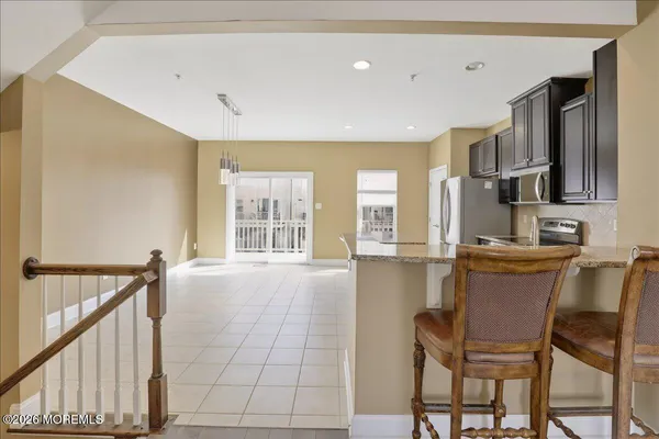 a large kitchen with stainless steel appliances granite countertop a stove a sink dishwasher and a refrigerator