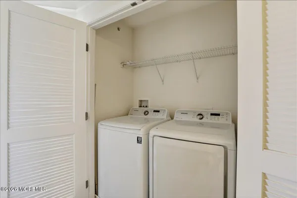 a front view of a building with lots of green space