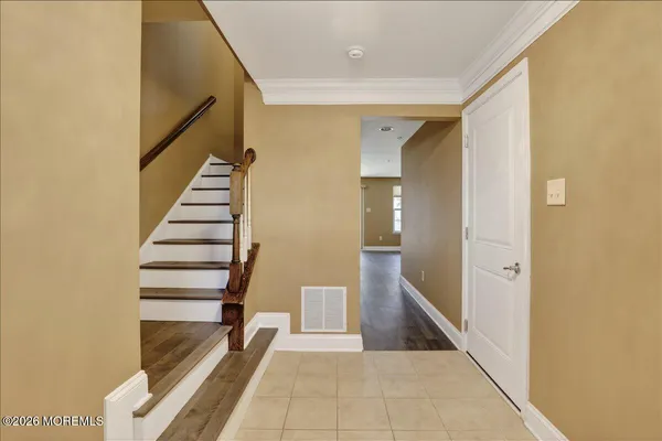 a view of entryway and hall with wooden floor