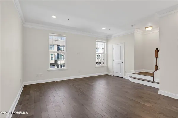 a view of a livingroom with furniture and hardwood floor