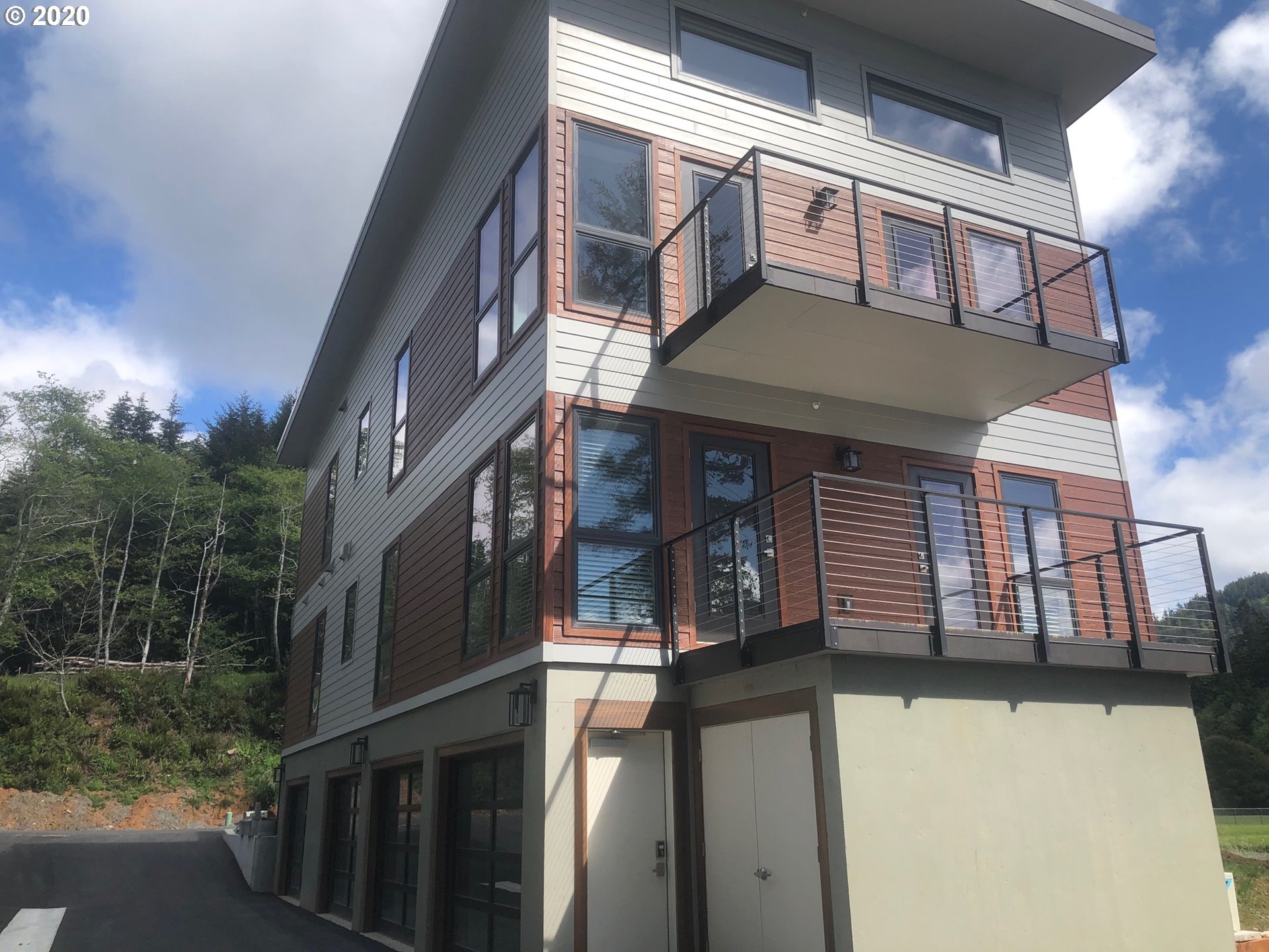 94353 Leith Road Gold Beach, OR 97444 - Photo 2 of 30 a front view of a house with a yard