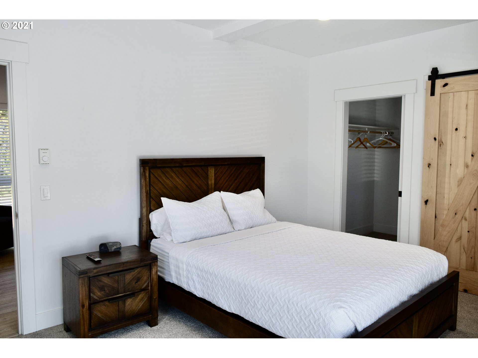 94353 Leith Road Gold Beach, OR 97444 - Photo 20 of 30 a bedroom with a bed and a mirror on dresser