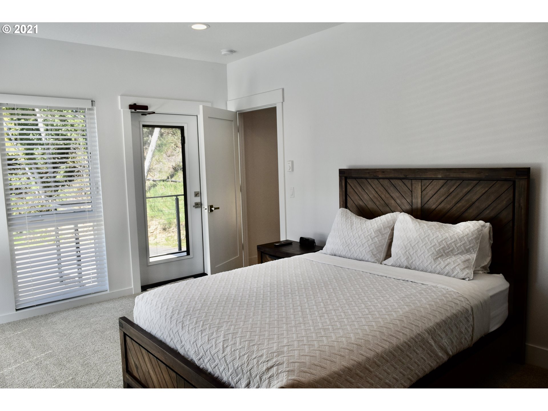 94353 Leith Road Gold Beach, OR 97444 - Photo 21 of 30 a bedroom with a large bed and a large window