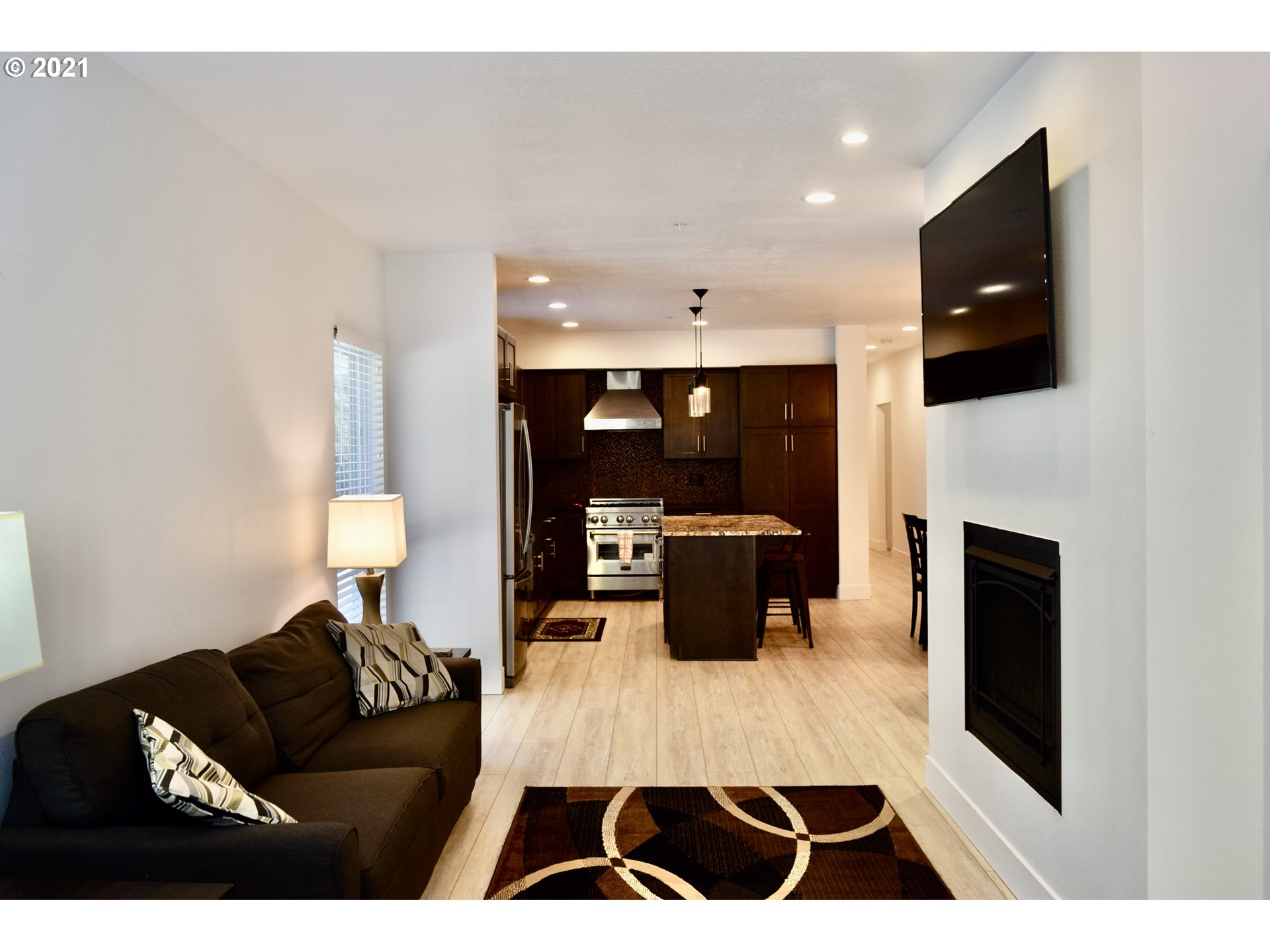 94353 Leith Road Gold Beach, OR 97444 - Photo 23 of 30 a living room with furniture a flat screen tv and a fireplace