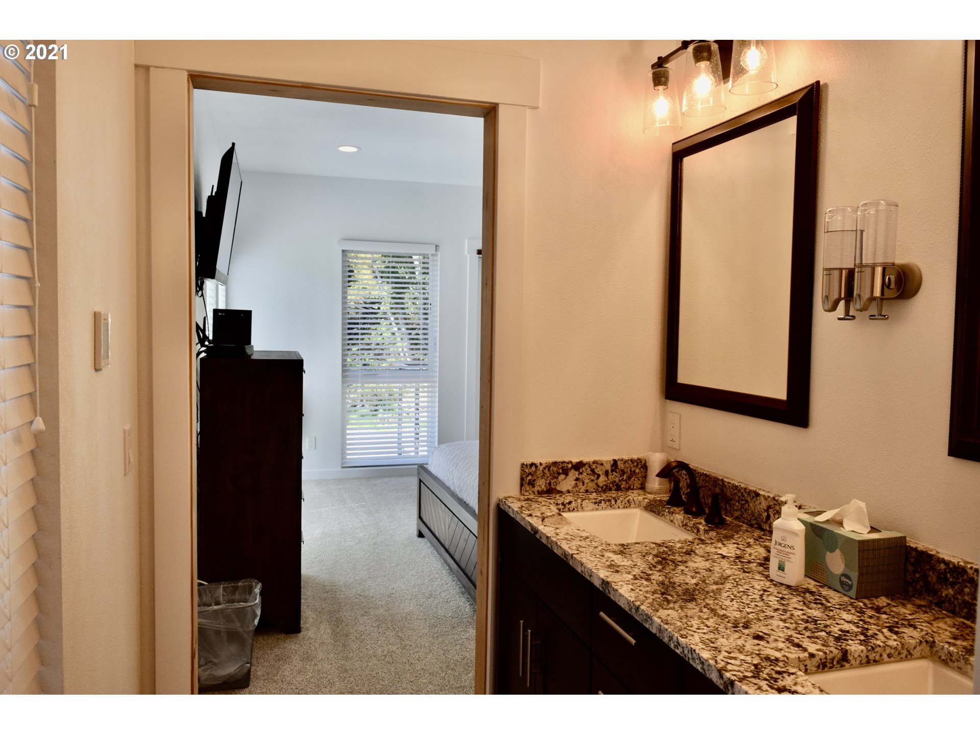 94353 Leith Road Gold Beach, OR 97444 - Photo 30 of 30 a bathroom with a granite countertop sink and mirror
