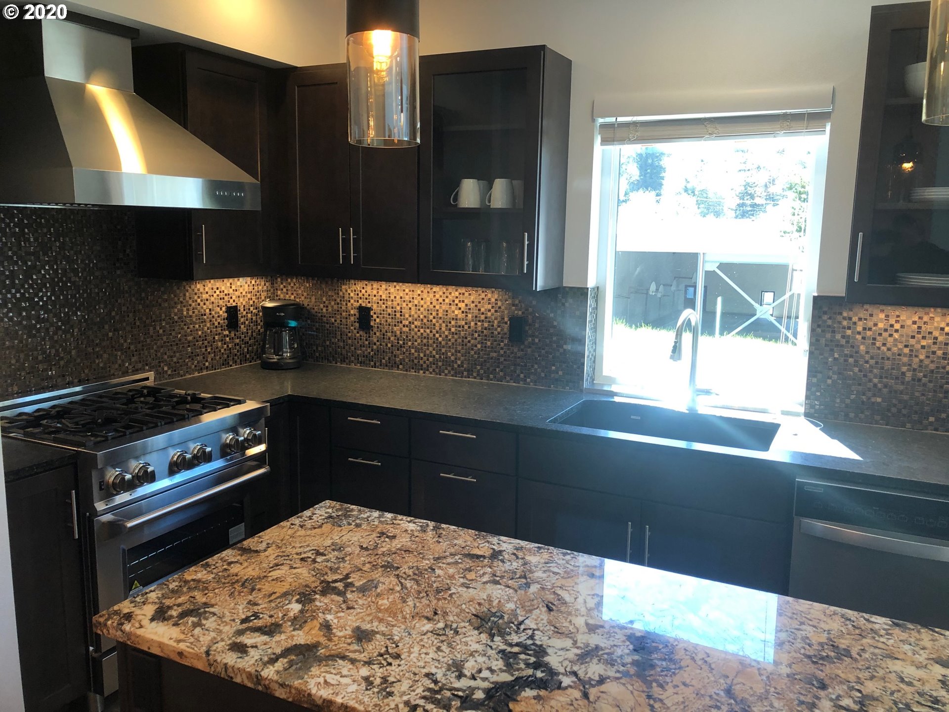94353 Leith Road Gold Beach, OR 97444 - Photo 7 of 30 a kitchen with a stove and a wooden cabinets