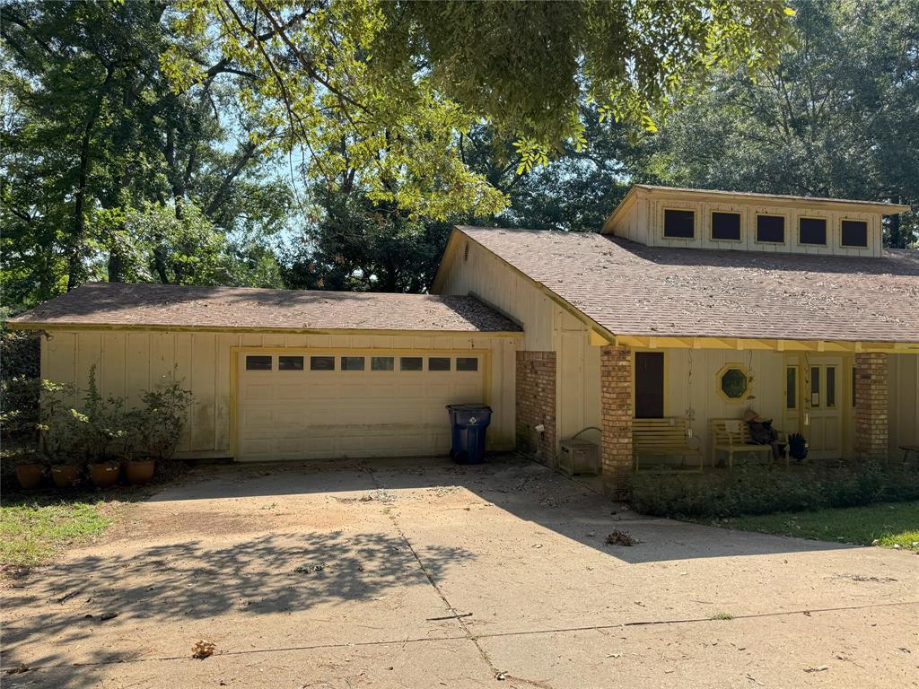 522 Twin Point Drive Benton, LA 71006 - Photo 3 of 33 View of front of home with concrete driveway, brick siding, an attached garage, and roof with shingles