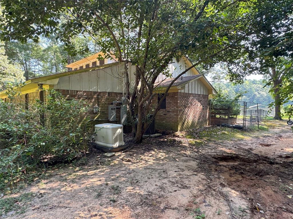 522 Twin Point Drive Benton, LA 71006 - Photo 6 of 33 View of property exterior featuring brick siding and board and batten siding