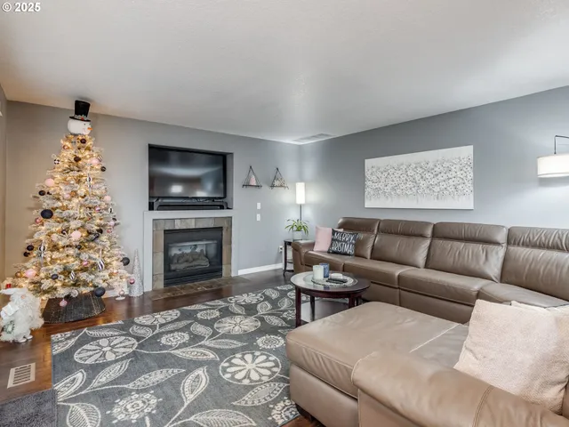 a living room with furniture a flat screen tv and a fireplace