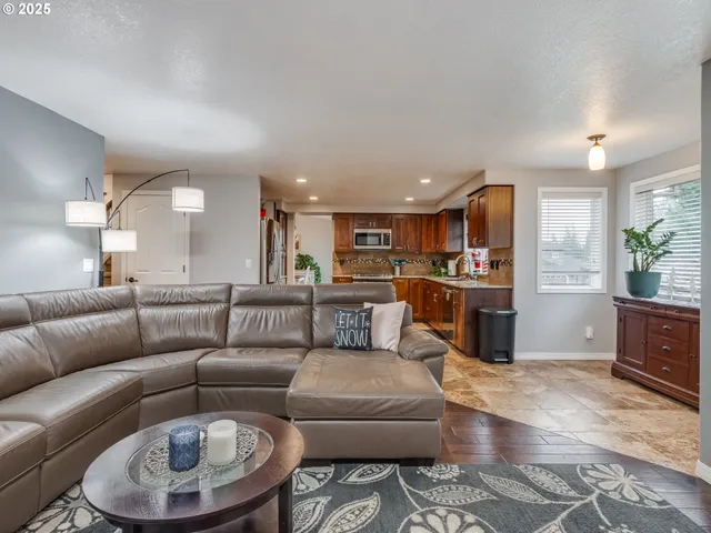 a living room with furniture and kitchen view