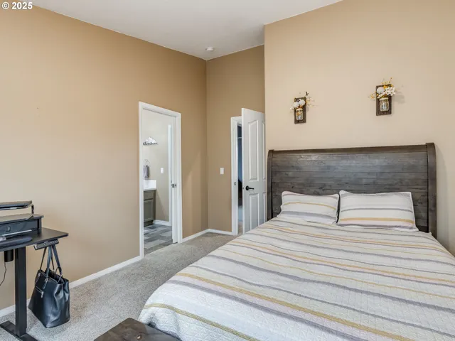 a bedroom with a bed and a chair