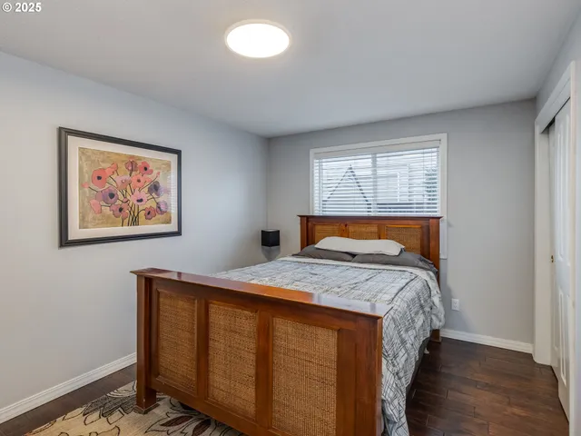a bed sitting in a bedroom next to a window