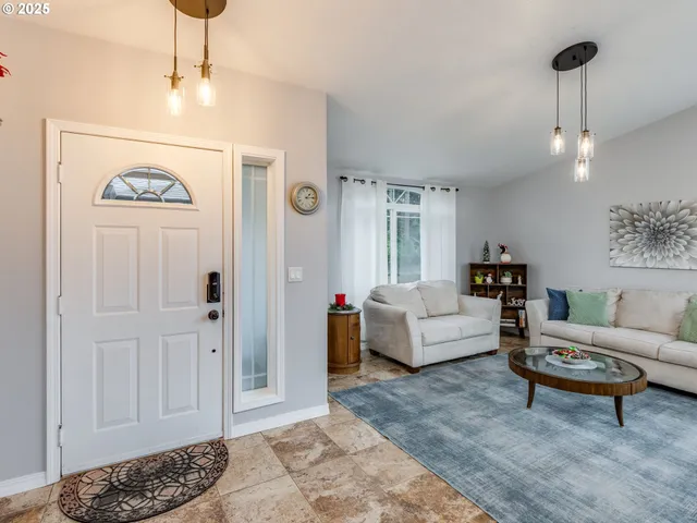 a living room with furniture and a chandelier