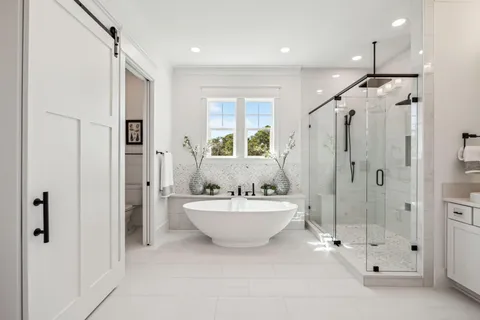 a spacious bathroom with a double vanity sink mirror and shower