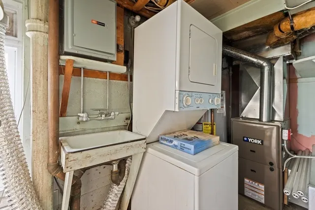 an empty room with windows wooden table and chair