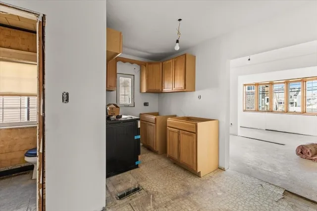 a kitchen that has a refrigerator and a stove